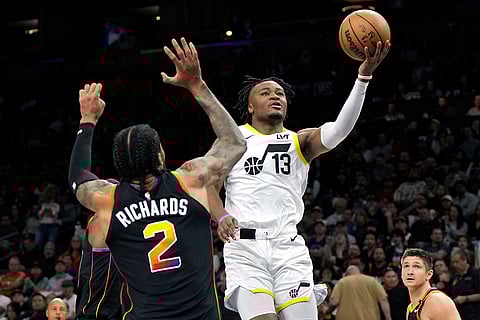 NBA 2024-25: Jazz guard Isaiah Collier drives on Suns Nick Richards