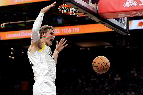 NBA 2024-25: Jazz forward Lauri Markkanen dunks against the Suns