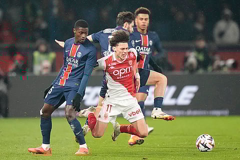 Ligue 1: PSG's Marquinhos, left, challenges Monaco's Maghnes Akliouche
