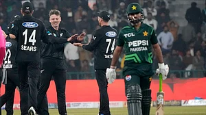 AP Photo/K.M. Chaudary : New Zealand's Michael Bracewell, second left, celebrates with teammates after taking the wicket of Pakistan's Babar Azam during the tri-series ODI match at Gaddafi Stadium in Lahore.