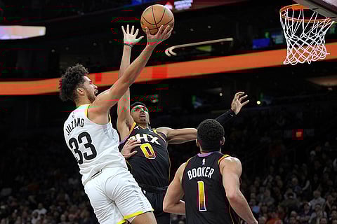 NBA 2024-25: Jazz guard Johnny Juzang shoots over Phoenix Suns forward Ryan Dunn