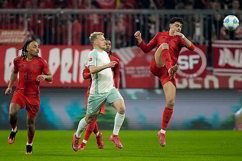 Bundesliga 2024-25: Bayern's Aleksandar Pavlovic fights for the ball with Bremen's Marco Gruell