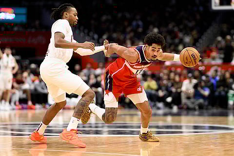 NBA 2024-25: Wizards guard Jordan Poole, right, drives to the basket against Cavaliers guard Darius Garland