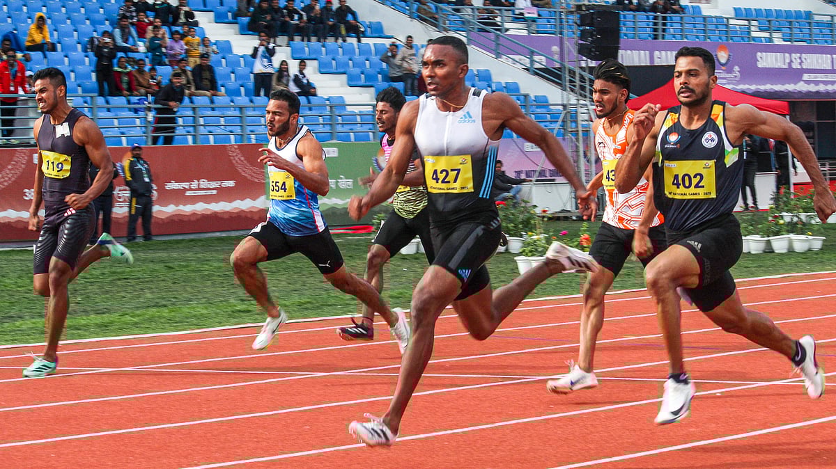 PTI : Athletes participate in the 100m race during the 38th National Games in Dehradun.