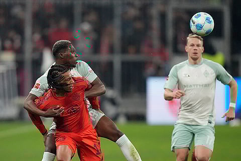 Bundesliga 2024-25: Bayern's Michael Olise fights for the ball with Bremen's Derrick Koehn
