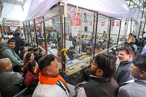 Election officials during the counting of votes for the Delhi polls