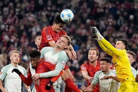 Bundesliga 2024-25: Bremen's goalkeeper Michael Zetterer, right, goes up for a save against Bayern's Kim Min-jae
