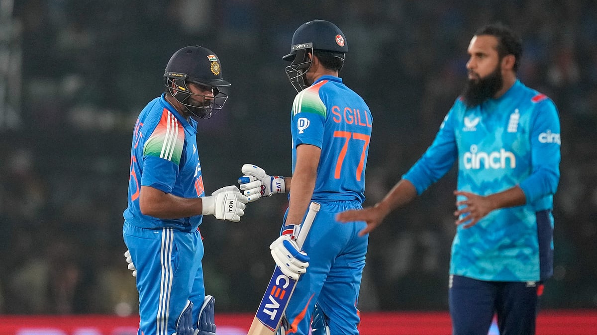 AP Photo/Rafiq Maqbool : Indian captain Rohit Sharma, left, is greeted by his batting partner Shubman Gill after scoring fifty runs during the second one day international cricket match between India and England in Cuttack.