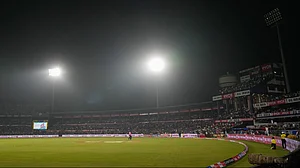AP Photo/Rafiq Maqbool : The umpires walked back towards the pavilion after play was stopped due to a technical issue with one of the floodlights during the second one day international cricket match between India and England in Cuttack.