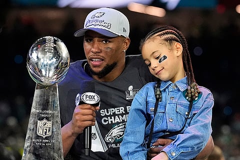 NFL Super Bowl 59 football, Eagles vs Chiefs: Eagles running back Saquon Barkley holds his daughter Jada 