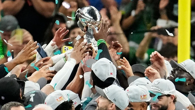 Philadelphia Eagles players holds the Vince Lombardi Trophy after the NFL Super Bowl 59 football game against the Kansas City Chiefs. - AP/Gerald Herbert