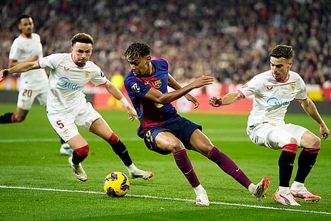 La Liga 2024-25: Barcelona's Lamine Yamal controls the ball between Sevilla's Ruben Vargas