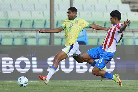 CONMEBOL U20 Championship: Brazil's Gustavo Prado runs for the ball chased by Paraguay's Angel Aguayo