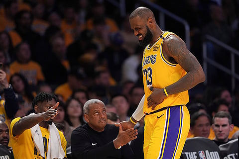 NBA 2024-25: Lakers forward LeBron James holds his side after a collision