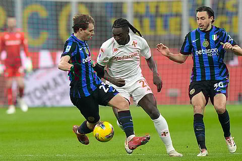 Serie A: Fiorentina's Moise Kean challenges for the ball with Inter Milan's Matteo Darmian and Nicolo Barella