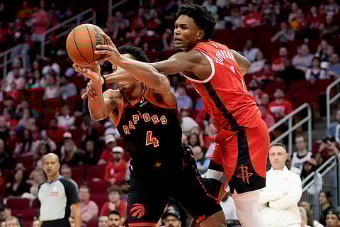 NBA 2024-25: Rockets forward Amen Thompson fouls Raptors forward Scottie Barnes