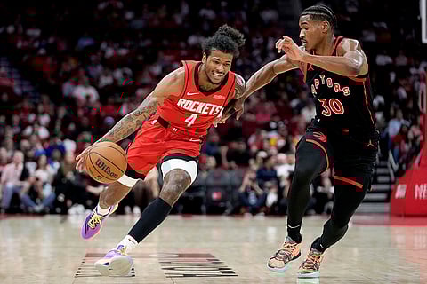 NBA 2024-25: Rockets guard Jalen Green (4) dribbles as Raptors guard Ochai Agbaji