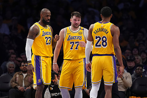 NBA 2024-25: Lakers guard Luka Doncic (77) confers with teammates forward LeBron James and forward Rui Hachimura