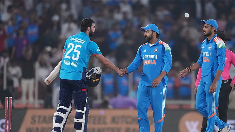 India's captain Rohit Sharma, second from right, shakes hand with England's Saqib Mahmood, left, after winning the third one day international cricket match and series against England in Ahmedabad. - AP Photo/ Ajit Solanki