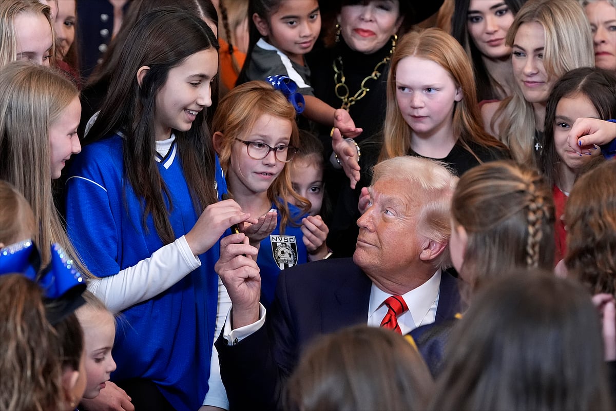  (AP Photo/Alex Brandon) : President Donald Trump hands out pens after signing an executive order barring transgender female athletes from competing in women's or girls' sporting events, in the East Room of the White House, Wednesday, Feb. 5, 2025, in Washington.