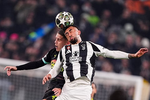 Champions League playoff first leg: PSV's Joey Veerman jumps for the ball with Juventus' Nico Gonzalez