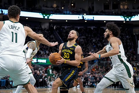 NBA 2024-25: Warriors' Stephen Curry (30) goes up against Milwaukee Bucks' palyers