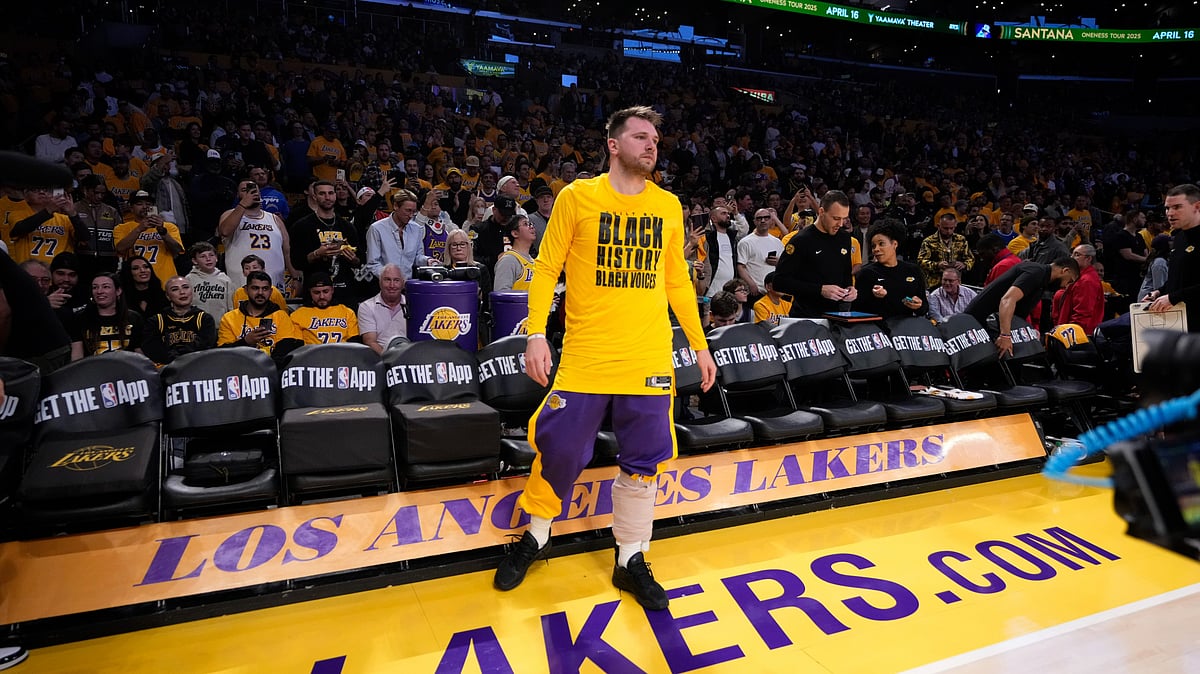 (AP Photo/Mark J. Terrill) : Los Angeles Lakers guard Luka Doncic walks onto the court before an NBA basketball game against the Utah Jazz, Monday, Feb. 10, 2025, in Los Angeles. 