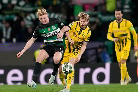Champions League playoff first leg: Sporting's Conrad Harder challenges for the ball with Dortmund's Daniel Svensson