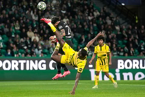 Champions League playoff first leg: Dortmund's Serhou Guirassy challenges for the ball with Sporting's Maximiliano Araujo