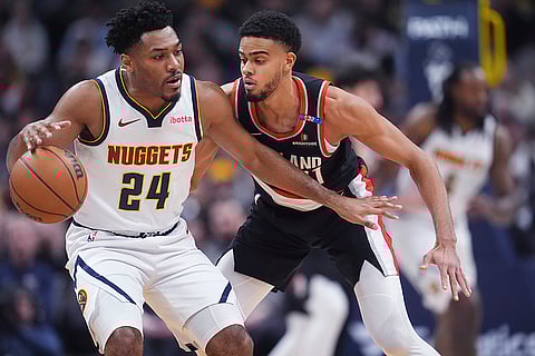 NBA 2024-25: Nuggets guard Jalen Pickett protects the ball as Trail Blazers guard Rayan Rupert defends