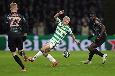 Champions League playoff first leg: Celtic's Daizen Maeda, Bayern's Konrad Laimer and Bayern's Dayot Upamecano challenge for the ball