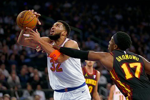 NBA 2024-25: Knicks center Karl-Anthony Towns (32) is fouled by  Hawks forward Onyeka Okongwu