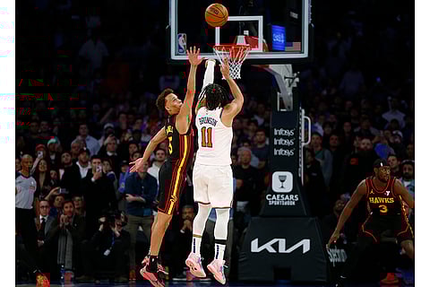 NBA 2024-25: Knicks guard Jalen Brunson hits a basket over Hawks guard Dyson Daniels