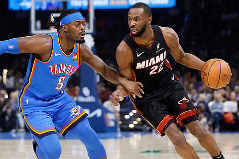 NBA 2024-25: Heat forward Andrew Wiggins (22) drives against Thunder guard Luguentz Dort