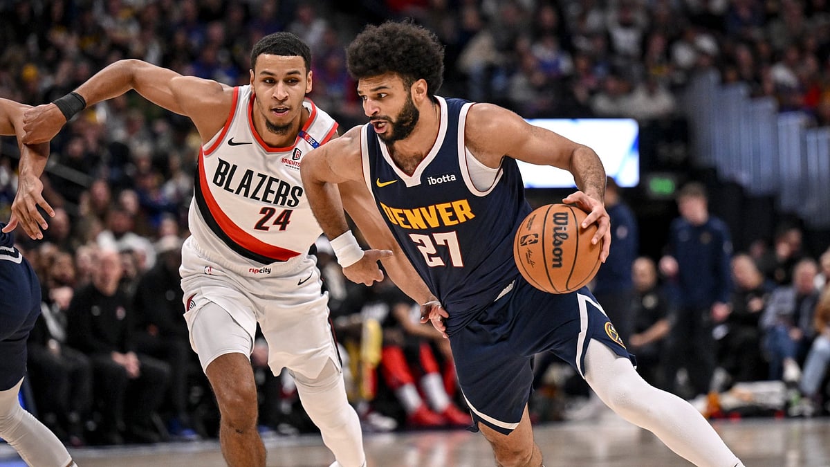 Jamal Murray (27) of the Denver Nuggets handles as Kris Murray (24) of the Portland Trail Blazers defends during the third quarter at Ball Arena in Denver, Colorado on Wednesday, February 12, 2025. - null