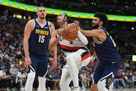 NBA 2024-25: Trail Blazers guard Dalano Banton is fouled by Denver Nuggets guard Jamal Murray
