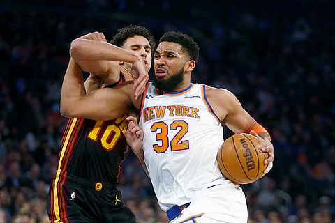 NBA 2024-25: Knicks center Karl-Anthony Towns (32) drives past Hawks forward Zaccharie Risacher