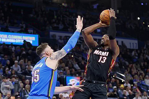 NBA 2024-25: Heat center Bam Adebayo (13) looks to shoot over Thunder center Isaiah Hartenstein