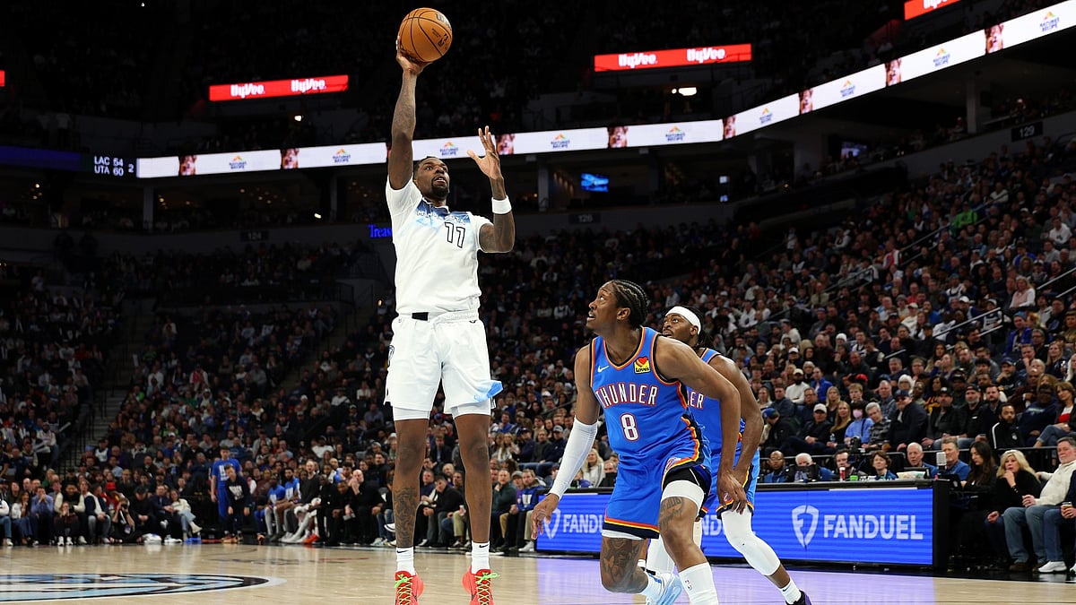 Naz Reid #11 of the Minnesota Timberwolves shoots the ball against Jalen Williams #8 of the Oklahoma City Thunder in the third quarter at Target Center on February 13, 2025 in Minneapolis, Minnesota