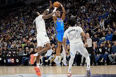 NBA 2024-25: Thunder guard Shai Gilgeous-Alexander (2) shoots over Timberwolves center Naz Reid