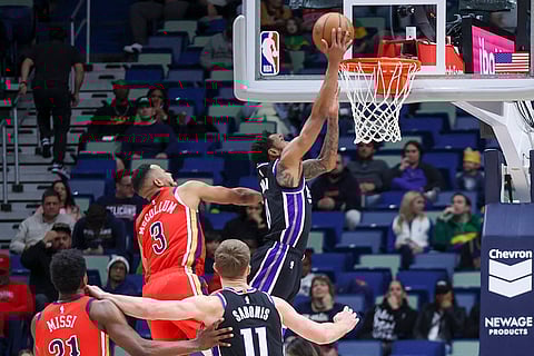 NBA 2024-25: Kings guard Malik Monk (0) drives past Pelicans guard CJ McCollum