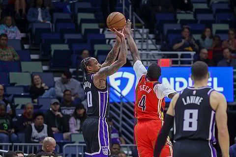 NBA 2024-25: Kings forward DeMar DeRozan (10) shoots a three-pointer over New Orleans Pelicans guard Javonte Green