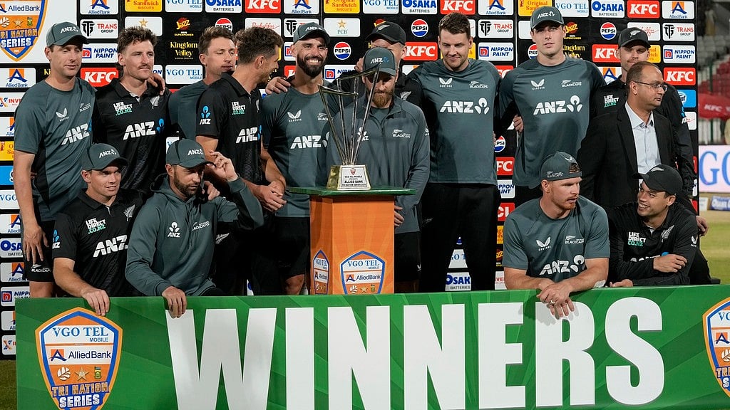 AP/Fareed Khan : New Zealand's players pose for photo with trophy after winning the tri-series final against Pakistan, in Karachi, Pakistan, Friday, Feb. 14, 2025.
