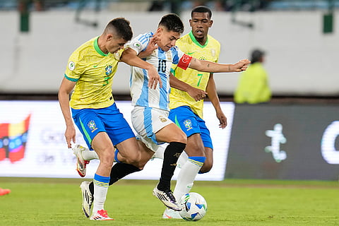 U-20 South American Championship: Argentina's Claudio Echeverri dribbles between Brazil's Jair and Rayan