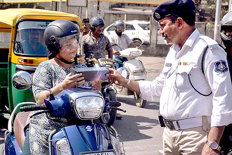 Traffic police gives gift to bike rider