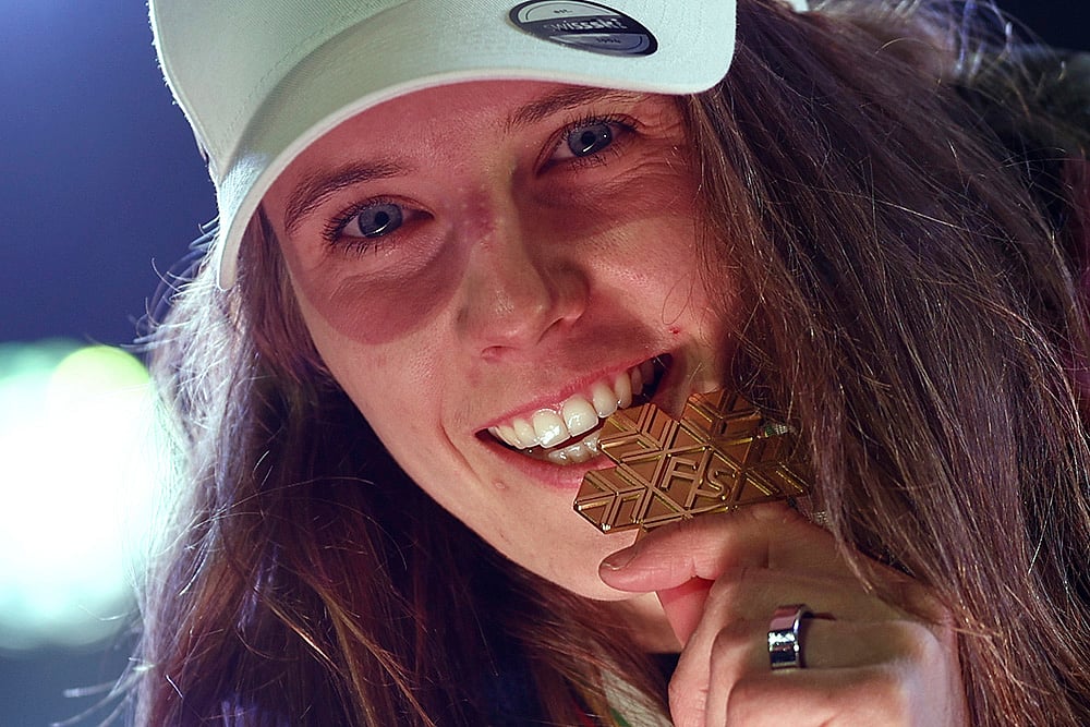 | Photo: AP/Gabriele Facciotti : Austria Ski Worlds: Switzerland's Camille Rast bites her gold medal 