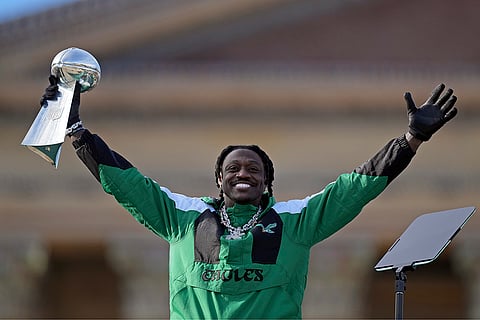 Super Bowl Eagles Parade: Eagles wide receiver A.J. Brown reacts as he holds up the Lombardi Trophy