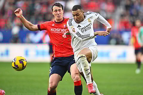 La Liga  2024-25: Real Madrid's Kylian Mbappe is challenged by Osasuna's Jorge Herrando