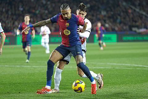 La Liga 2024-25: Barcelona's Raphinha challenges for the ball with Rayo's Andrei Ratiu