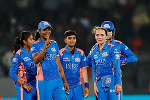 X/@wplt20 : MI players erupt in celebration after taking a wicket against GG.